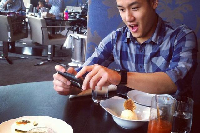Asian taking picture of Asian taking picture of food